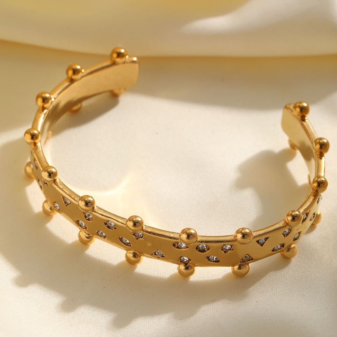 Gold studded hand cuff